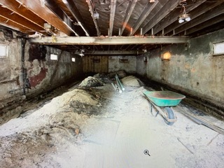 A room with lots of dirt and debris on the floor.