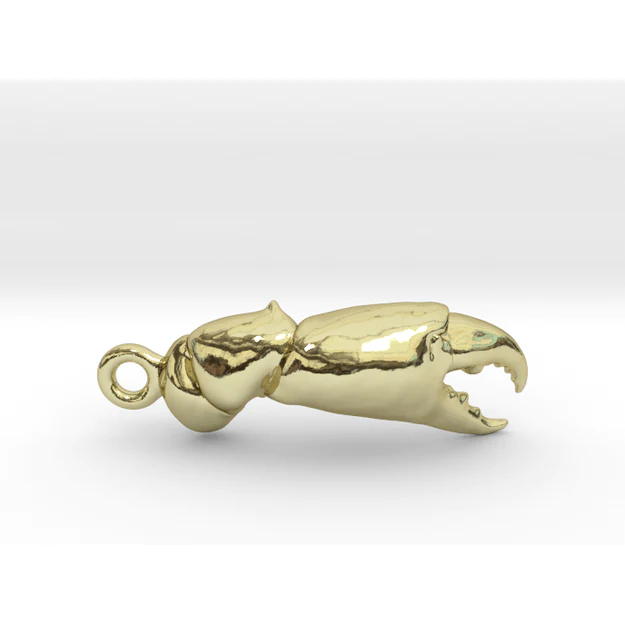 A gold plated animal shaped charm with a lobster claw.