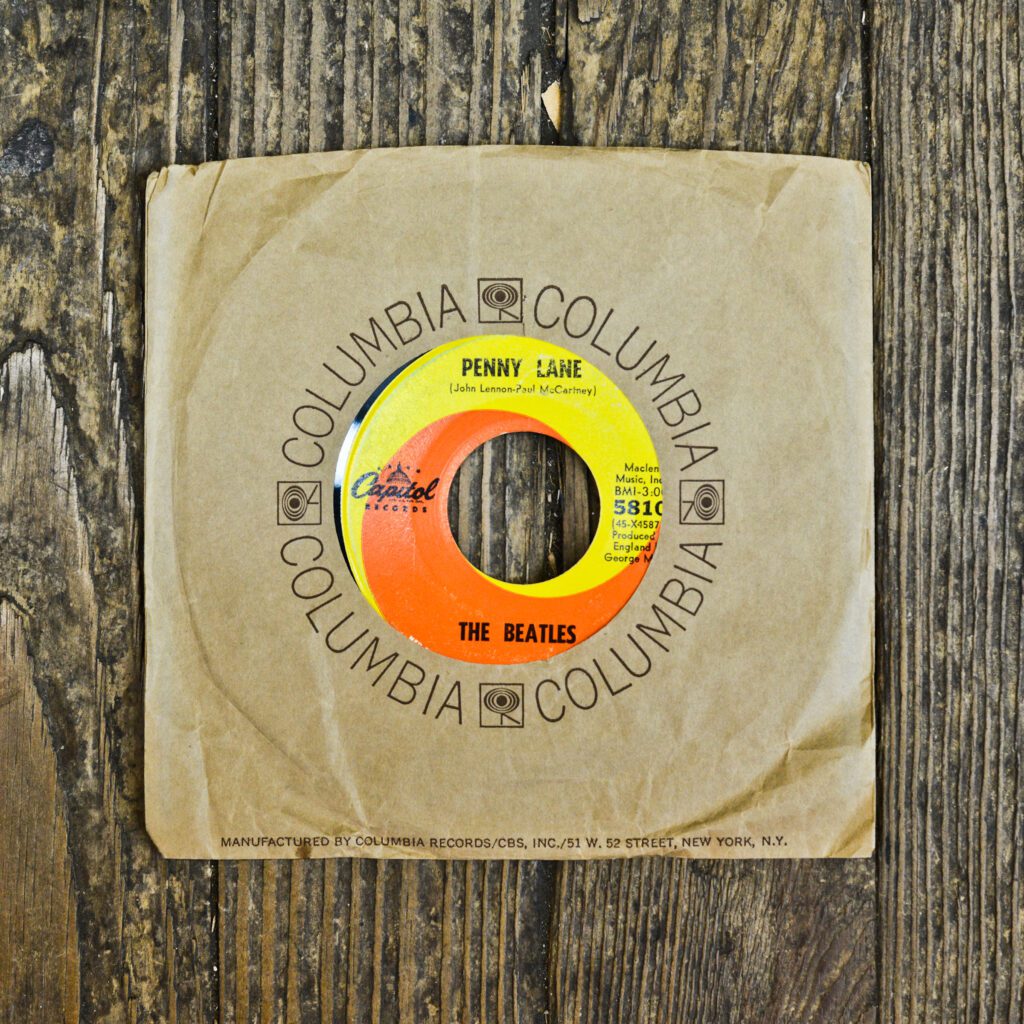 A yellow and orange record sitting on top of a wooden table.